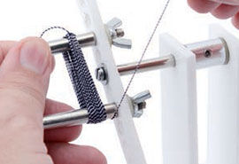 Holding the freed strand of material